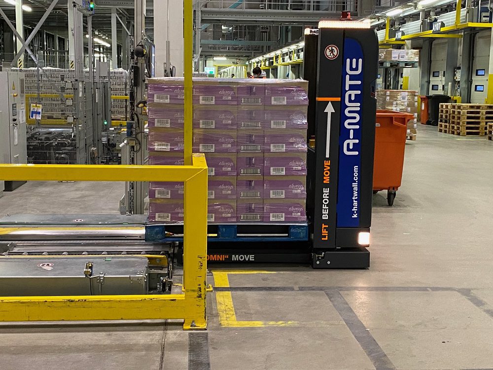 A-MATE lifting pallet onto conveyor system with 360 degree safety